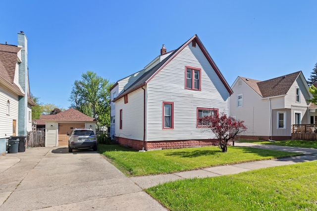 532 Chestnut St, Wyandotte, MI 48192 - view of front facade featuring a front lawn, a detached garage, and a chimney