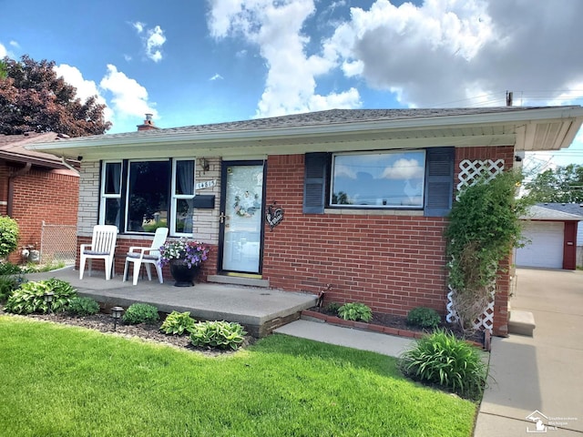 14815 Morris Ave, Allen Park, MI 48101 - view of front of house with brick siding, a front lawn, covered porch, and concrete driveway