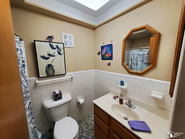 14815 Morris Ave, Allen Park, MI 48101 - bathroom with tile walls, a wainscoted wall, toilet, and vanity