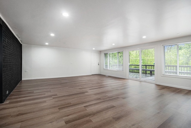 16114 Alpine Dr, Livonia, MI 48154 - unfurnished living room featuring wood finished floors, baseboards, and recessed lighting