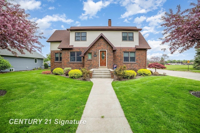 9610 Saginaw St, Reese, MI 48757 - view of front of property with a chimney, a front yard, and brick siding