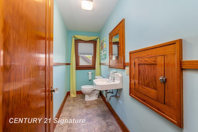 9610 Saginaw St, Reese, MI 48757 - bathroom with toilet, baseboards, and a sink