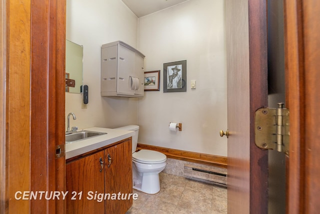 9610 Saginaw St, Reese, MI 48757 - bathroom featuring a baseboard radiator, toilet, tile patterned floors, and vanity