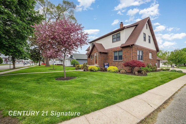 9610 Saginaw St, Reese, MI 48757 - view of front facade featuring a chimney, brick siding, and a front lawn