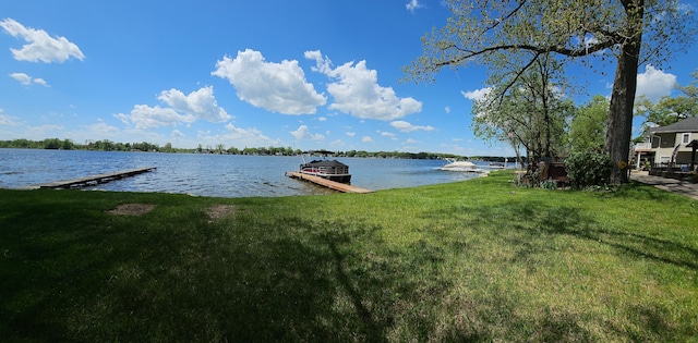 dock area with a yard and a water view