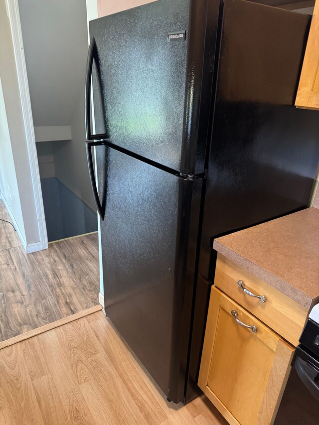 35221 Tall Oaks Dr, Sterling Heights, MI 48312 - kitchen with freestanding refrigerator, light wood-style flooring, and light countertops