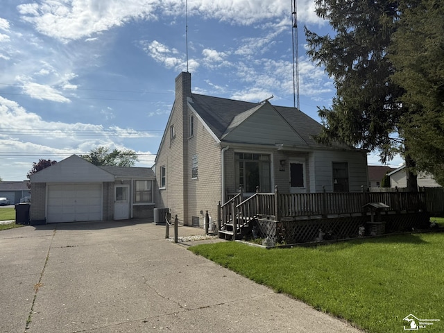 4971 Elm St, Newport, MI 48166 - bungalow featuring central AC, concrete driveway, a front yard, an attached garage, and brick siding