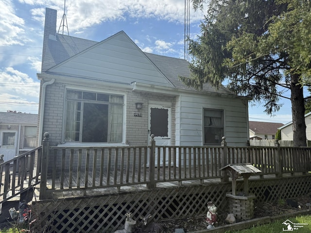 4971 Elm St, Newport, MI 48166 - back of property featuring a deck, a chimney, and brick siding