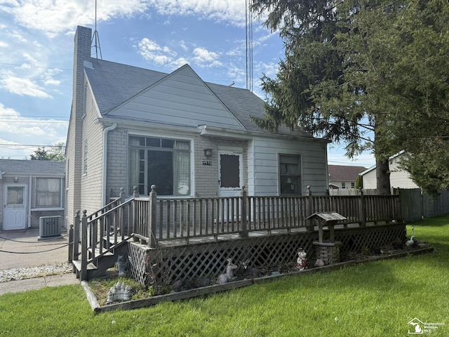 4971 Elm St, Newport, MI 48166 - bungalow-style house with central AC unit, a wooden deck, a front lawn, and a chimney