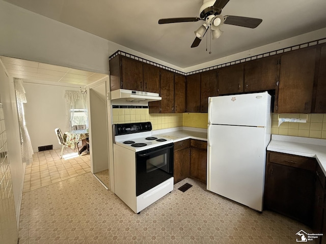 4971 Elm St, Newport, MI 48166 - kitchen featuring freestanding refrigerator, electric stove, under cabinet range hood, light countertops, and dark brown cabinets