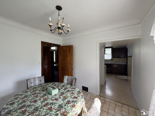 4971 Elm St, Newport, MI 48166 - dining space featuring a chandelier and baseboards