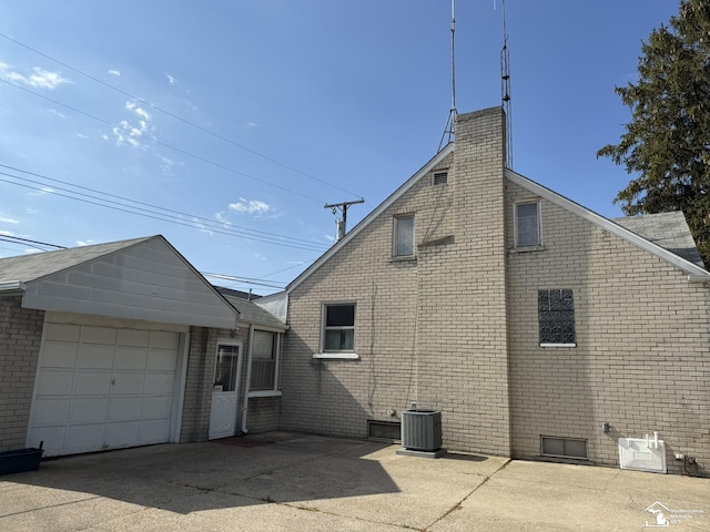 4971 Elm St, Newport, MI 48166 - view of side of property with central air condition unit, brick siding, and a chimney