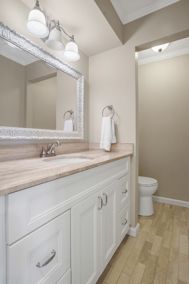 1663 Tacoma Dr, Rochester Hills, MI 48306 - bathroom featuring wood finished floors, vanity, crown molding, toilet, and baseboards