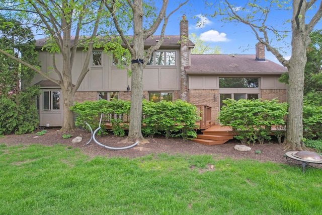 1663 Tacoma Dr, Rochester Hills, MI 48306 - back of property featuring brick siding, a deck, a yard, and a chimney