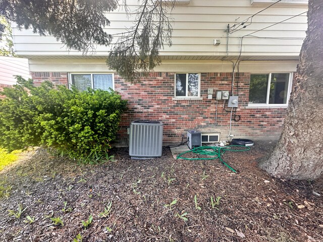 32336 Lancaster Dr, Warren, MI 48088 - exterior view of cooling unit, brick siding, and electric meter