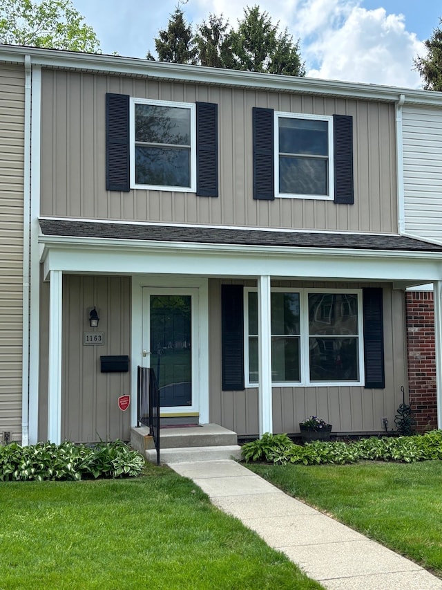1163 Marquette Ct, Rochester Hills, MI 48307 - view of front of home with a front lawn and board and batten siding