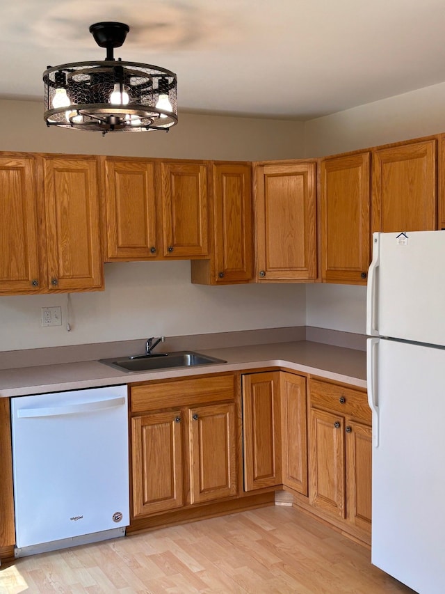 1163 Marquette Ct, Rochester Hills, MI 48307 - kitchen featuring white appliances, a sink, brown cabinetry, and light wood-type flooring