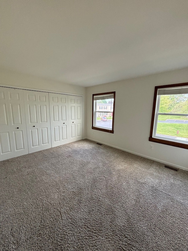 1163 Marquette Ct, Rochester Hills, MI 48307 - unfurnished bedroom with carpet flooring, a closet, and baseboards