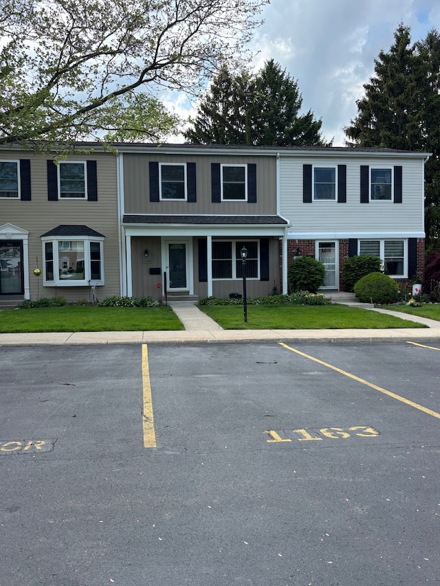 1163 Marquette Ct, Rochester Hills, MI 48307 - view of property featuring uncovered parking, a front yard, and a porch