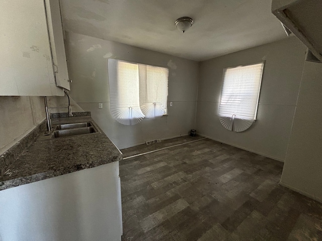 16828 W Chicago St, Detroit, MI 48228 - kitchen with white cabinetry, dark countertops, a sink, and dark wood-style flooring