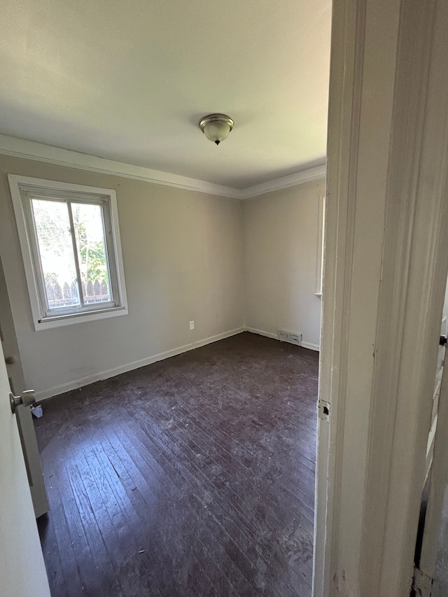 16828 W Chicago St, Detroit, MI 48228 - empty room with dark wood-type flooring, ornamental molding, and baseboards