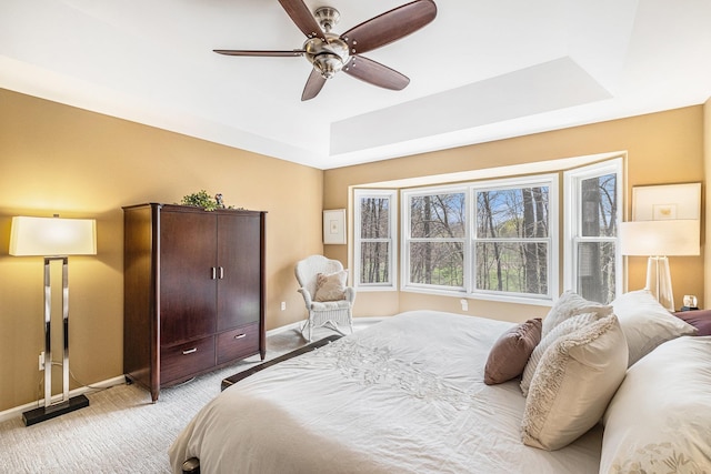 5489 Hidden Oak Cir, Linden, MI 48451 - bedroom featuring light carpet, a raised ceiling, baseboards, and a ceiling fan