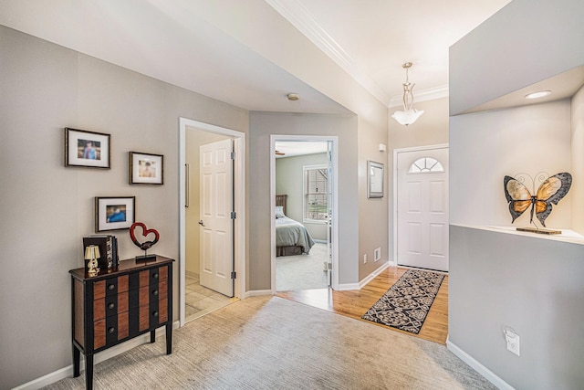 5489 Hidden Oak Cir, Linden, MI 48451 - entrance foyer featuring ornamental molding, baseboards, light colored carpet, and light wood-type flooring