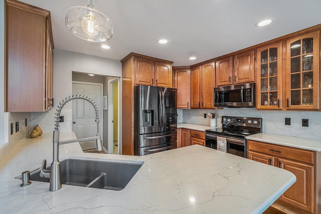 5489 Hidden Oak Cir, Linden, MI 48451 - kitchen with stainless steel appliances, a sink, glass insert cabinets, brown cabinetry, and recessed lighting