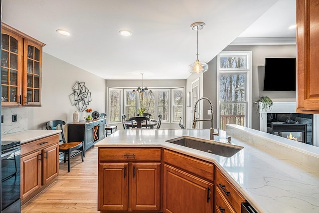 5489 Hidden Oak Cir, Linden, MI 48451 - kitchen featuring a sink, light wood-style floors, glass insert cabinets, brown cabinetry, and recessed lighting