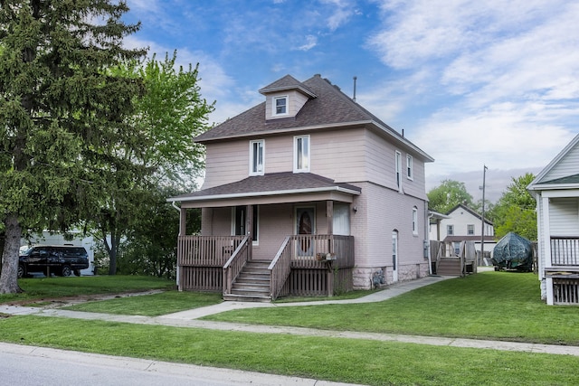 1309 Division St, Port Huron, MI 48060 - american foursquare style home featuring roof with shingles, a porch, and a front lawn