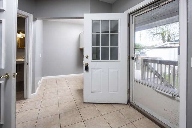 1309 Division St, Port Huron, MI 48060 - doorway with light tile patterned flooring and baseboards