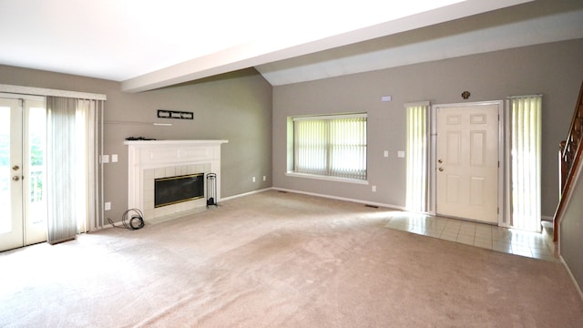 2 Cornell Ct, Dearborn, MI 48124 - unfurnished living room featuring carpet flooring, a tiled fireplace, baseboards, lofted ceiling, and tile patterned floors