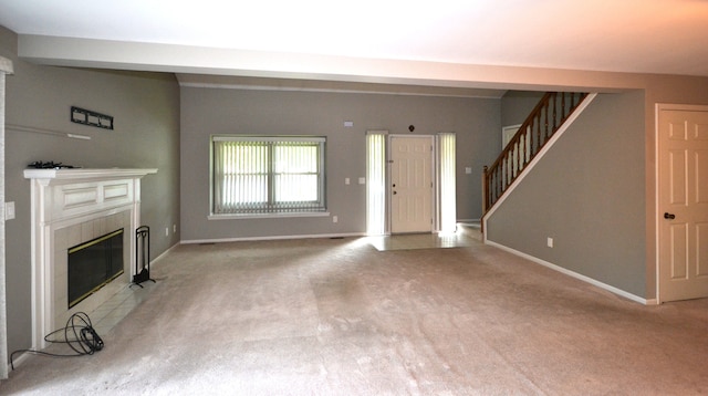 2 Cornell Ct, Dearborn, MI 48124 - unfurnished living room with a tiled fireplace, light colored carpet, stairs, and baseboards