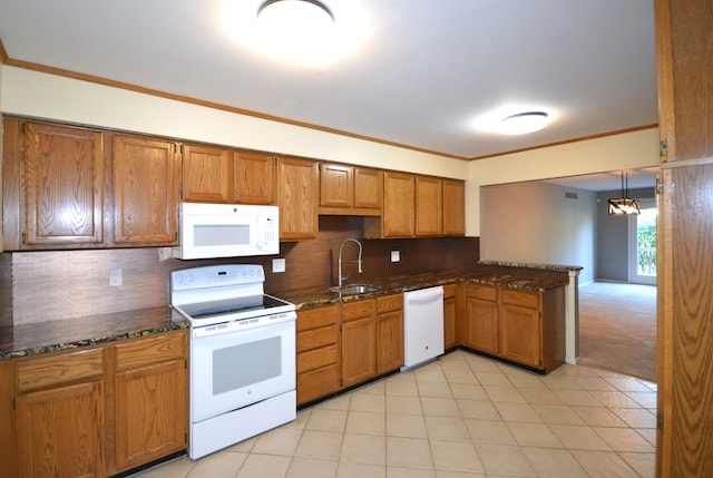 2 Cornell Ct, Dearborn, MI 48124 - kitchen featuring white appliances, a sink, brown cabinetry, a peninsula, and decorative backsplash