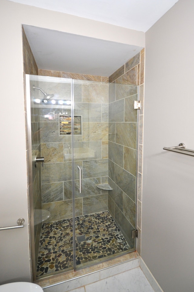 2 Cornell Ct, Dearborn, MI 48124 - bathroom with marble look tiles, a stall shower, baseboards, and toilet