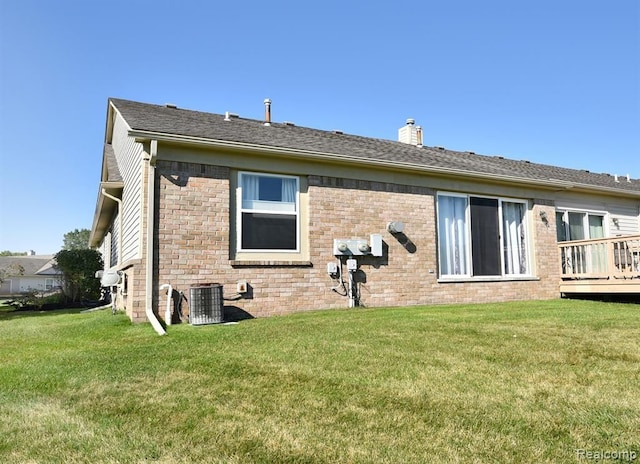 34214 Birchway Cir, Sterling Heights, MI 48312 - back of house featuring a chimney, a lawn, brick siding, and central AC unit
