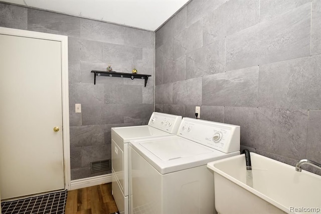 34214 Birchway Cir, Sterling Heights, MI 48312 - laundry room with tile walls, separate washer and dryer, and wood finished floors