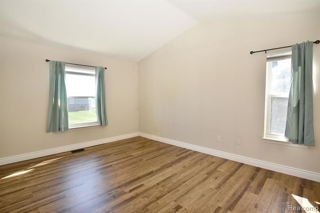 34214 Birchway Cir, Sterling Heights, MI 48312 - spare room featuring wood finished floors, healthy amount of natural light, lofted ceiling, and baseboards
