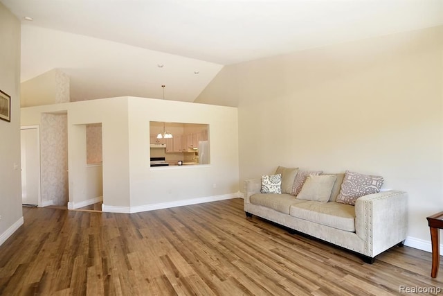 34214 Birchway Cir, Sterling Heights, MI 48312 - living area with wood finished floors, baseboards, and high vaulted ceiling