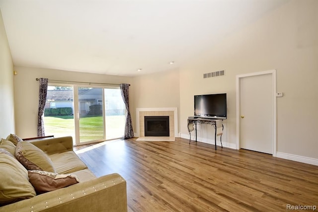 34214 Birchway Cir, Sterling Heights, MI 48312 - living room with wood finished floors, baseboards, and a tiled fireplace
