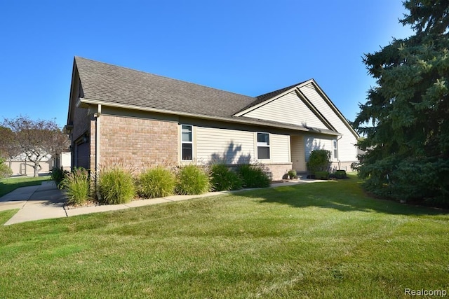 34214 Birchway Cir, Sterling Heights, MI 48312 - view of side of home with brick siding, a lawn, roof with shingles, and a garage