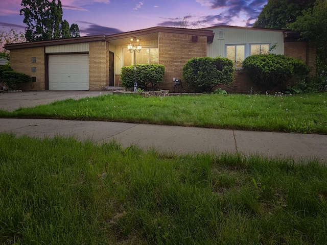 24161 Beverly St, Oak Park, MI 48237 - single story home with brick siding, a garage, driveway, and a front yard
