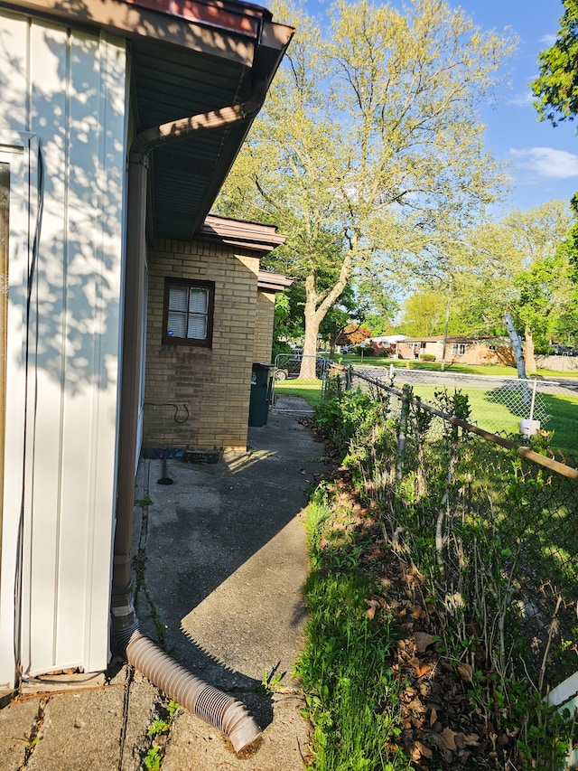 24161 Beverly St, Oak Park, MI 48237 - view of home's exterior featuring fence, board and batten siding, and brick siding