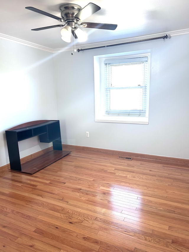 1840 Brentwood Dr, Troy, MI 48098 - unfurnished living room featuring ceiling fan, ornamental molding, wood finished floors, and baseboards