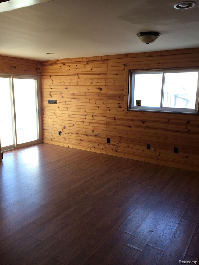 164 W Morehouse Ave N, Hazel Park, MI 48030 - empty room with healthy amount of natural light, wood walls, and dark wood finished floors