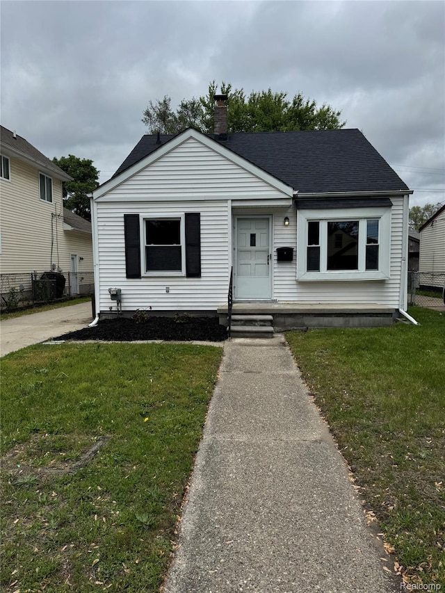 164 W Morehouse Ave N, Hazel Park, MI 48030 - view of front of property with a chimney, a shingled roof, and entry steps