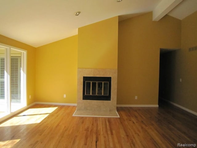 6850 Arlington, West Bloomfield, MI 48322 - unfurnished living room featuring wood finished floors, baseboards, and a tiled fireplace