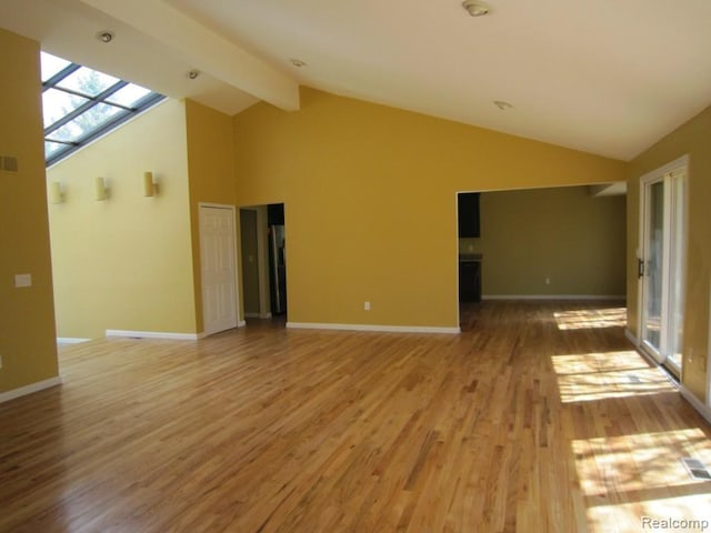 6850 Arlington, West Bloomfield, MI 48322 - spare room with light wood finished floors, baseboards, healthy amount of natural light, high vaulted ceiling, and beam ceiling