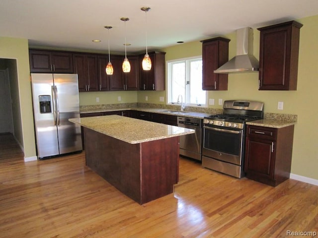 6850 Arlington, West Bloomfield, MI 48322 - kitchen with stainless steel appliances, wall chimney exhaust hood, a sink, a kitchen island, and light wood-style floors