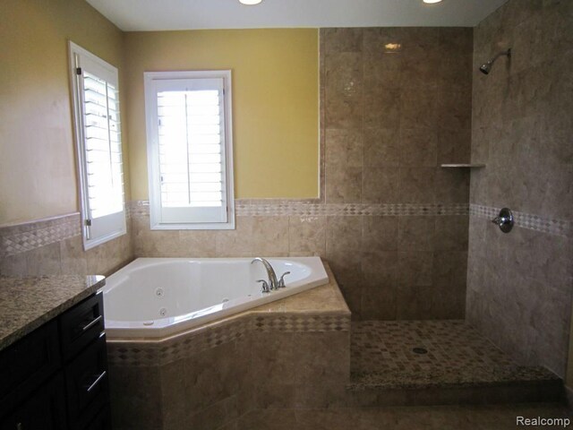 6850 Arlington, West Bloomfield, MI 48322 - bathroom with a tub with jets, vanity, a tile shower, and tile walls